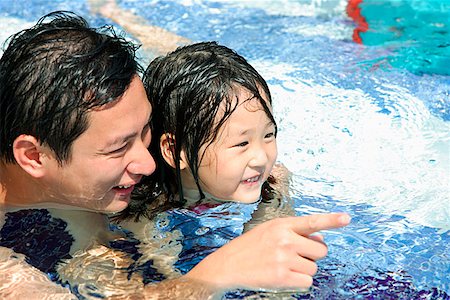 simsearch:656-01773586,k - Father and daughter in swimming pool, father pointing with finger Stock Photo - Premium Royalty-Free, Code: 656-01769081