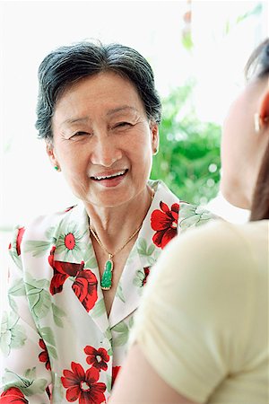 smiling senior people talking family - Mother with adult daughter, over the shoulder view Stock Photo - Premium Royalty-Free, Code: 656-01769278