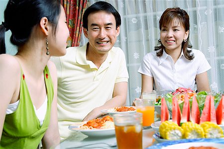 family condo - Family with teenage daughter at dining table Stock Photo - Premium Royalty-Free, Code: 656-01769318