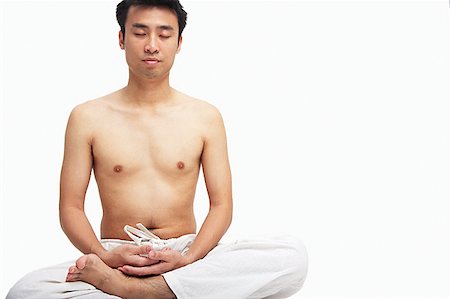 simsearch:656-01765715,k - Man sitting in lotus position, eyes closed Stock Photo - Premium Royalty-Free, Code: 656-01769456