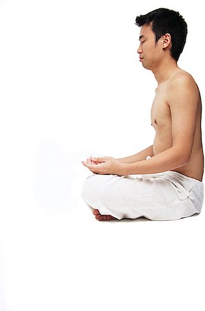 Man sitting in lotus position, side view Stock Photo - Premium Royalty-Free, Code: 656-01769457