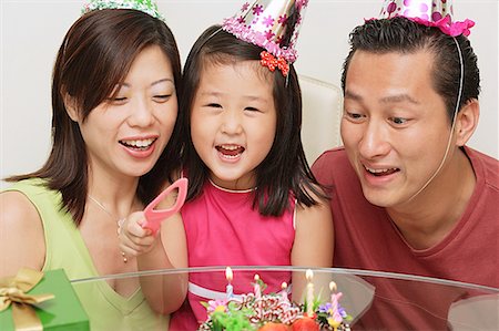 Family with one child celebrating a birthday Stock Photo - Premium Royalty-Free, Code: 656-01769495