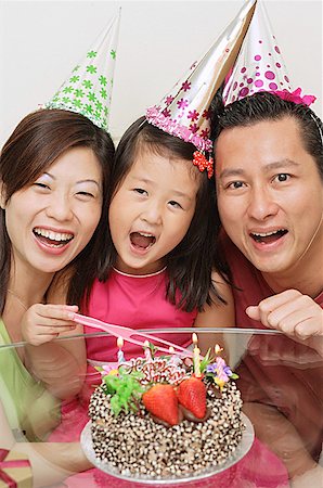 east asian ethnicity girl cake - Family with one daughter celebrating a birthday Stock Photo - Premium Royalty-Free, Code: 656-01769496