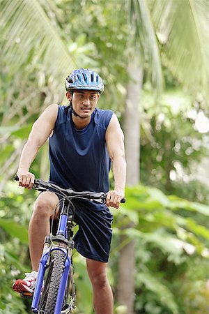 Man riding bicycle Stock Photo - Premium Royalty-Free, Code: 656-01769545