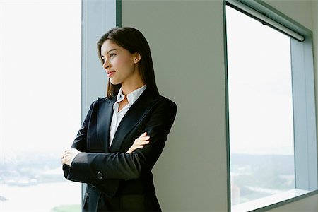 exotic - Businesswoman standing next to window in conference room, arms crossed Stock Photo - Premium Royalty-Free, Code: 656-01769964