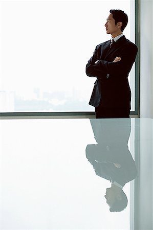 Businessman standing with arms crossed Stock Photo - Premium Royalty-Free, Code: 656-01769998