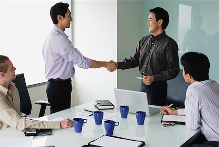 Executives in meeting room, shaking hands Stock Photo - Premium Royalty-Free, Code: 656-01770056