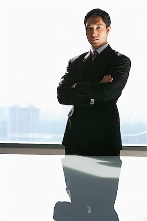 Businessman standing with arms crossed, looking at camera Stock Photo - Premium Royalty-Free, Code: 656-01770098