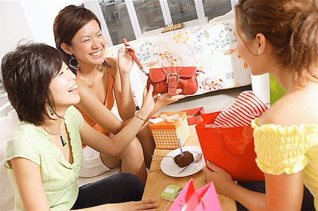 simsearch:656-01765624,k - Young women at home, celebrating birthday, opening gifts Stock Photo - Premium Royalty-Free, Code: 656-01770295