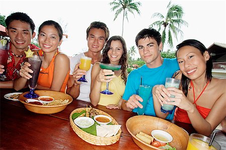 pic of friends in bar celebration - Couples with drinks at beach bar Stock Photo - Premium Royalty-Free, Code: 656-01770347