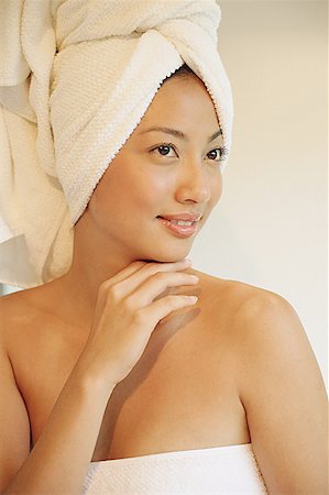 Woman wearing a towel, looking away, smiling Stock Photo - Premium Royalty-Free, Code: 656-01770409