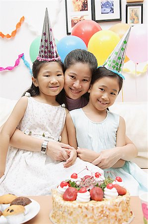 east asian ethnicity girl cake - Mother with two girls celebrating a birthday, smiling at camera Stock Photo - Premium Royalty-Free, Code: 656-01770518