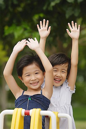 simsearch:656-01773586,k - Two girls on a seesaw, arms outstretched Stock Photo - Premium Royalty-Free, Code: 656-01770557