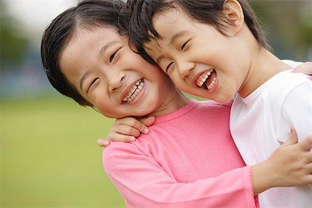 simsearch:656-01773586,k - Two girls with arms around each other, laughing, portrait Stock Photo - Premium Royalty-Free, Code: 656-01770575