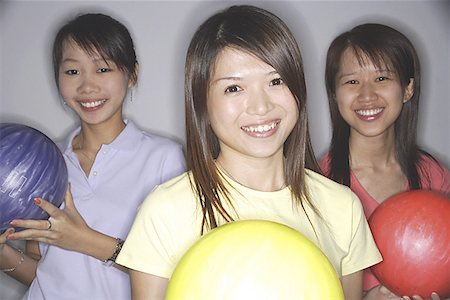 simsearch:656-01770739,k - Women holding bowling balls, smiling at camera Fotografie stock - Premium Royalty-Free, Codice: 656-01770657