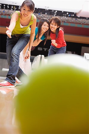 simsearch:693-06015216,k - Young woman bowling, friends watching behind her Stock Photo - Premium Royalty-Free, Code: 656-01770666