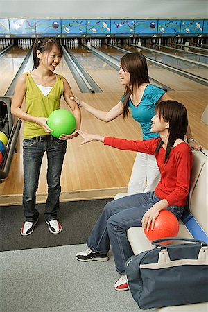 simsearch:656-01770739,k - Three women in bowling alley Fotografie stock - Premium Royalty-Free, Codice: 656-01770670