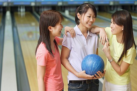 simsearch:656-01772843,k - Three women at bowling alley, talking Fotografie stock - Premium Royalty-Free, Codice: 656-01770722