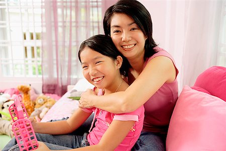 simsearch:656-01768177,k - Mother embracing daughter, both looking at camera Stock Photo - Premium Royalty-Free, Code: 656-01770889