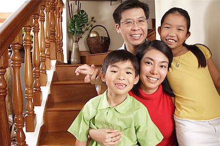 family condo - Family smiling at camera, portrait Stock Photo - Premium Royalty-Free, Code: 656-01770933