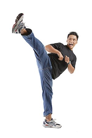 energized - Young man kicking Stock Photo - Premium Royalty-Free, Code: 656-01770945
