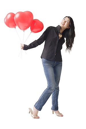 passion for shoes - Woman holding three red balloons, looking up Stock Photo - Premium Royalty-Free, Code: 656-01770960