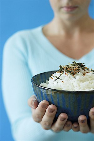 Woman holding bowl of rice, selective focus Stock Photo - Premium Royalty-Free, Code: 656-01771156