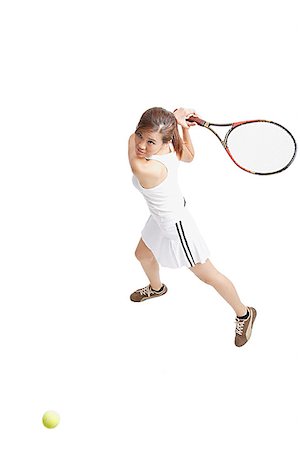 Young woman holding tennis racket waiting for ball Stock Photo - Premium Royalty-Free, Code: 656-01771251