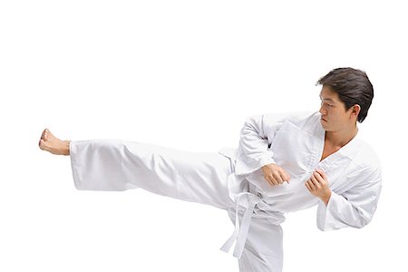 simsearch:656-03241028,k - Young man in martial arts uniform kicking Foto de stock - Sin royalties Premium, Código: 656-01771276