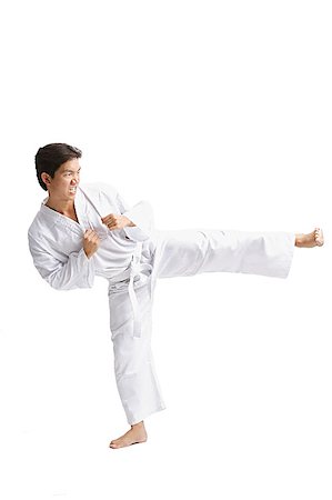 simsearch:656-03241028,k - Young man wearing martial arts uniform, standing on one leg Foto de stock - Sin royalties Premium, Código: 656-01771278