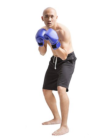simsearch:656-03241028,k - Young man wearing boxing gloves, facing camera Foto de stock - Sin royalties Premium, Código: 656-01771355