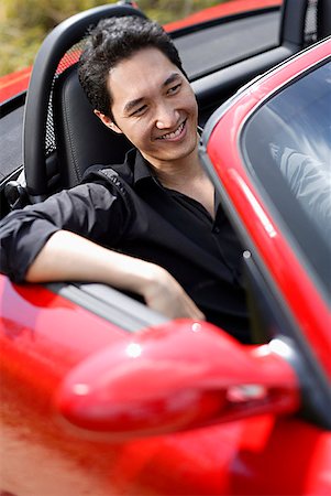 simsearch:655-02703059,k - Man sitting in red convertible car, smiling Stock Photo - Premium Royalty-Free, Code: 656-01771444