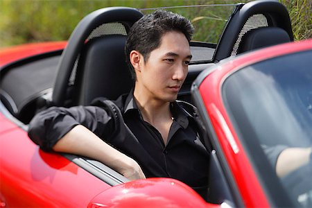 Man driving red convertible car Stock Photo - Premium Royalty-Free, Code: 656-01771446