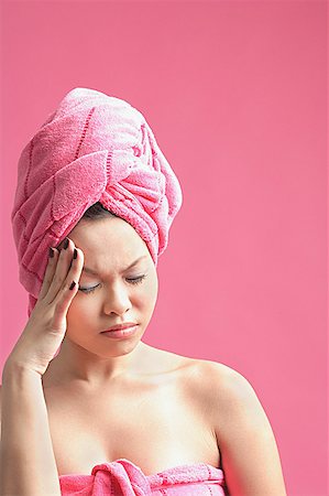 Woman wearing pink turban, frowning, eyes closed Stock Photo - Premium Royalty-Free, Code: 656-01771531