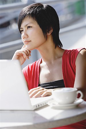 Woman at cafe with laptop Stock Photo - Premium Royalty-Free, Code: 656-01771589