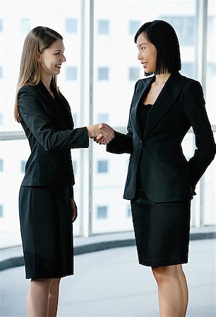 Two businesswomen shaking hands Stock Photo - Premium Royalty-Free, Code: 656-01771806