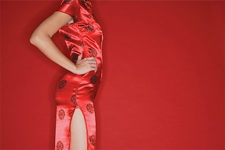 simsearch:642-02006591,k - Woman in cheongsam, hands on hips cropped Stock Photo - Premium Royalty-Free, Code: 656-01771894