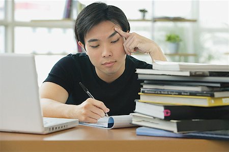 student computer writing - Young adult studying with laptop and books Stock Photo - Premium Royalty-Free, Code: 656-01771950