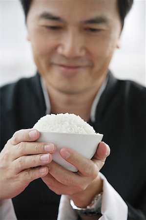 simsearch:656-01772085,k - Man holding bowl of rice Stock Photo - Premium Royalty-Free, Code: 656-01771978