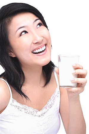 simsearch:656-01771940,k - Young woman with glass of milk, looking up Fotografie stock - Premium Royalty-Free, Codice: 656-01772003