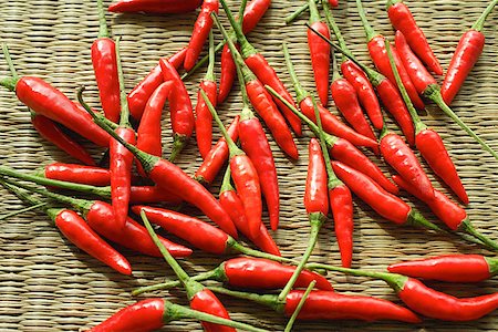 Still life of chilies against woven mat Stock Photo - Premium Royalty-Free, Code: 656-01772062