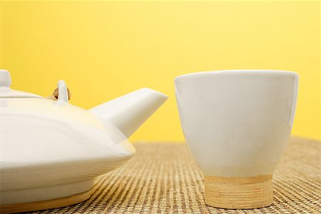 simsearch:656-01771172,k - Still life with Chinese teacup and teapot, against yellow wall Fotografie stock - Premium Royalty-Free, Codice: 656-01772074