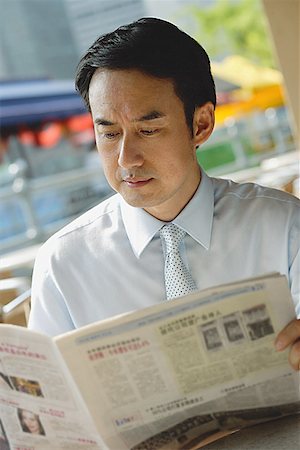 Businessman in cafe, reading newspaper Stock Photo - Premium Royalty-Free, Code: 656-01772129