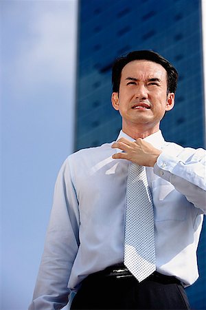 simsearch:694-03330980,k - Businessman frowning, adjusting tie Stock Photo - Premium Royalty-Free, Code: 656-01772244