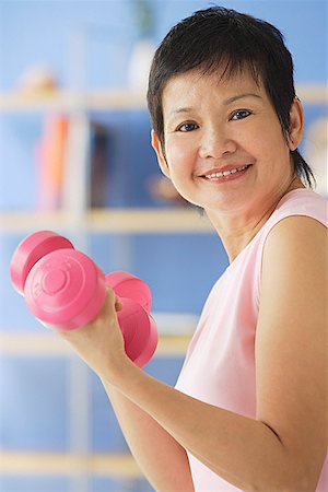 Mature woman holding dumbbells Stock Photo - Premium Royalty-Free, Code: 656-01772322