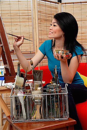 Woman painting on easel Stock Photo - Premium Royalty-Free, Code: 656-01772444