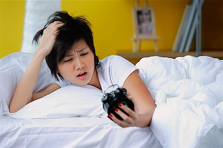 simsearch:656-01773560,k - Woman in bed, looking at alarm clock Stock Photo - Premium Royalty-Free, Code: 656-01772495