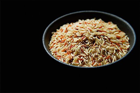 simsearch:656-01772085,k - Still life of Bowl of rice against black background Stock Photo - Premium Royalty-Free, Code: 656-01772638