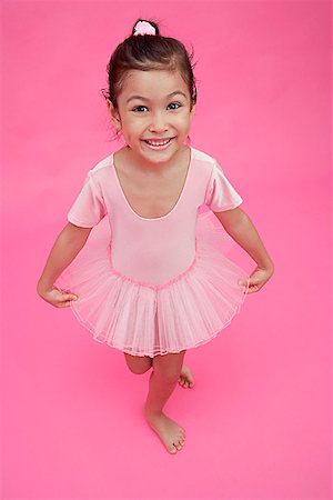 pink ballet tutu - Young girl in ballet outfit, smiling at camera Stock Photo - Premium Royalty-Free, Code: 656-01772787