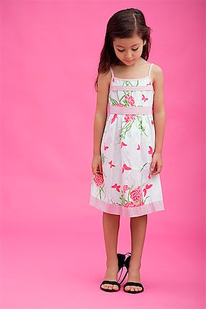 sad asian child - Young girl wearing high heel shoes, looking down Stock Photo - Premium Royalty-Free, Code: 656-01772781